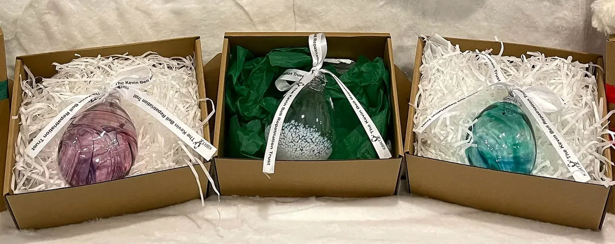 Berry, Clear and Green baubles, each in its gift box with the Trust ribbon