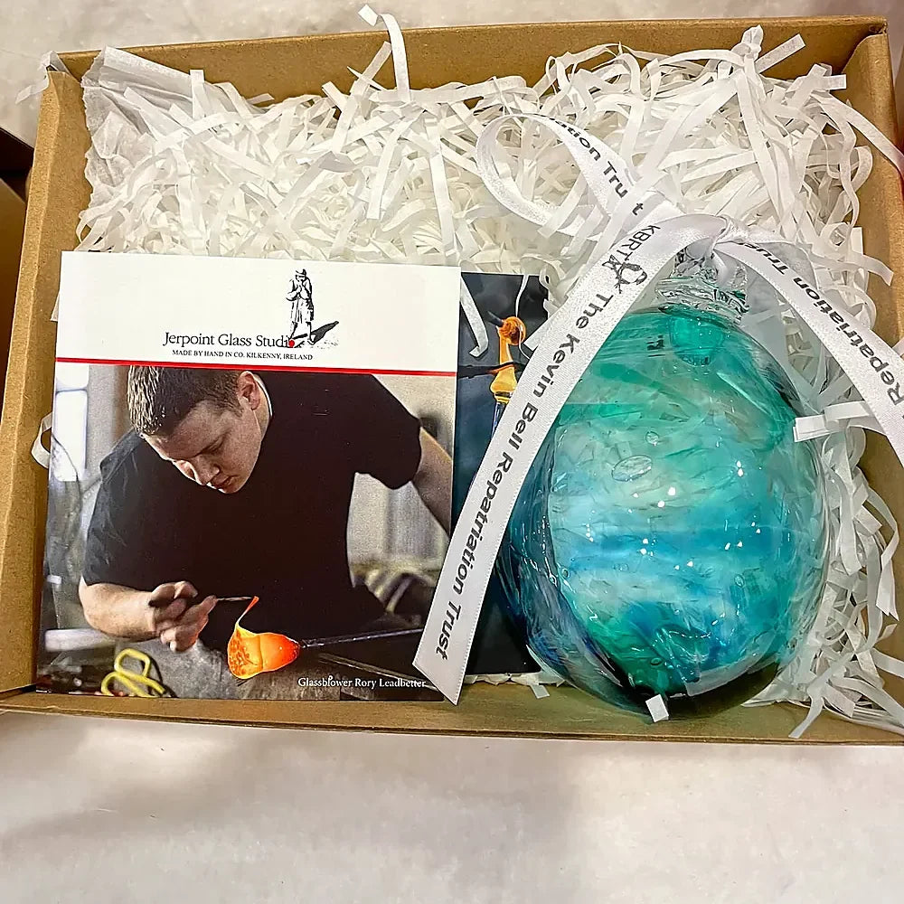 Bauble packed in its gift box beside the story card