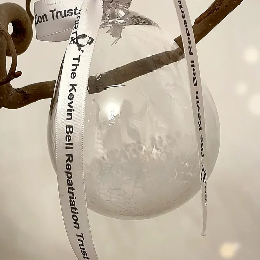 Clear hand-blown glass bauble with the Kevin Bell Repatriation Trust ribbon